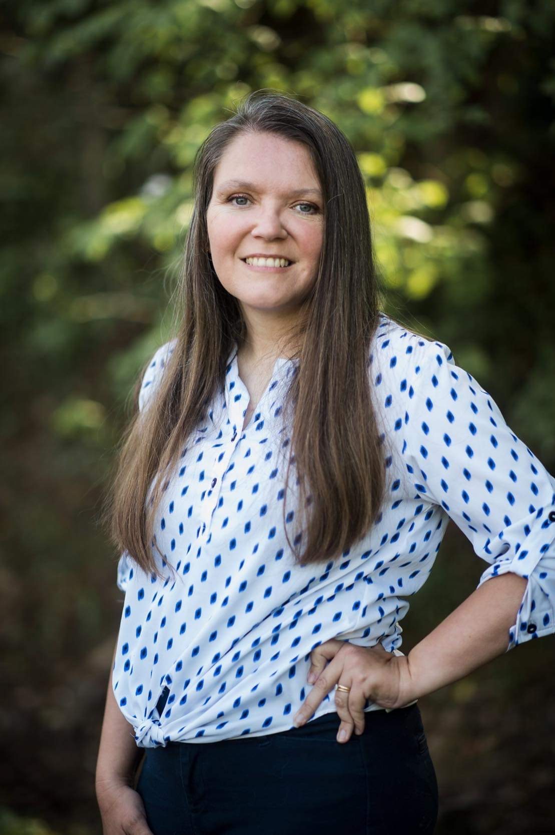 This Christian lifestyle blog owner Paula Jean standing by a copse of trees.