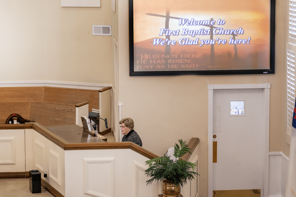 Lady playing the organ at a church. 